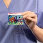 Healthcare nurse holding front facing pediatric design fair card